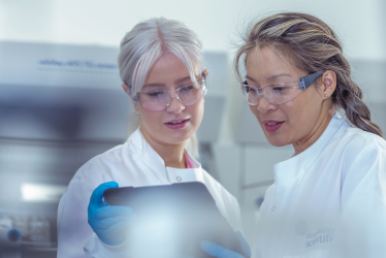 Researchers looking over tablet of data