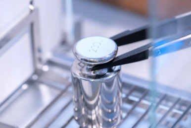 Calibration weight placed on analytical balance