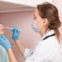 Medical professional taking nasopharynx sample from young girl
