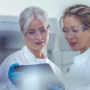 Researchers looking over tablet of data