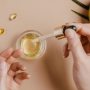 Hands with beauty products open on table